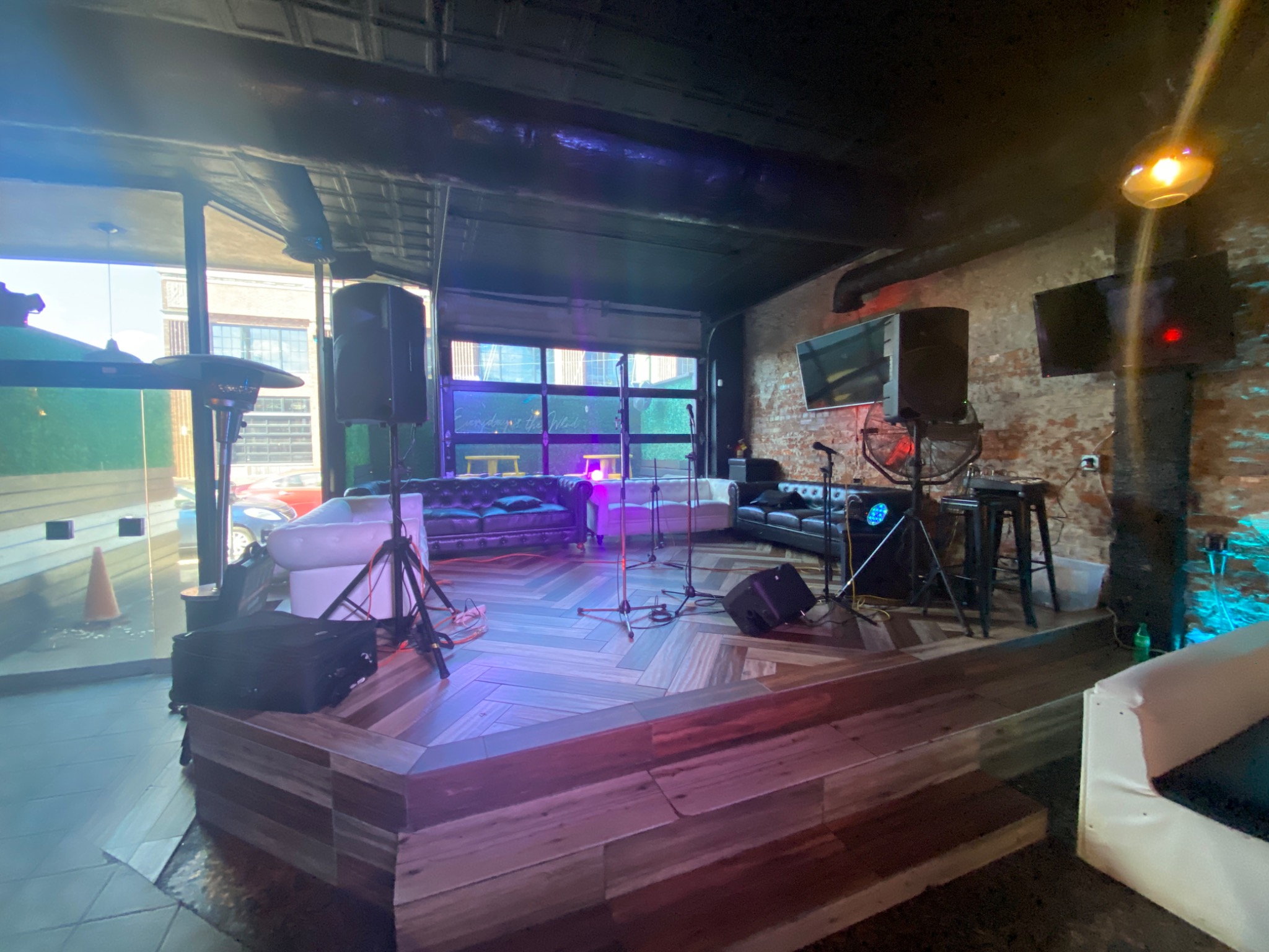 Lounge performance room with speakers, microphones, and lighting